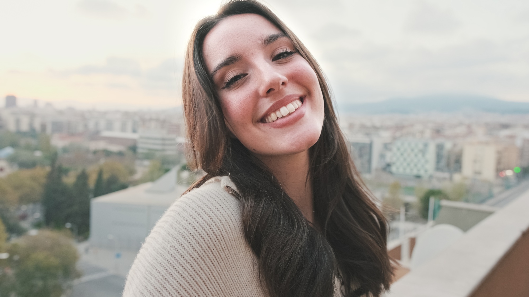 Beautiful young woman with charming smile posing at the camera
